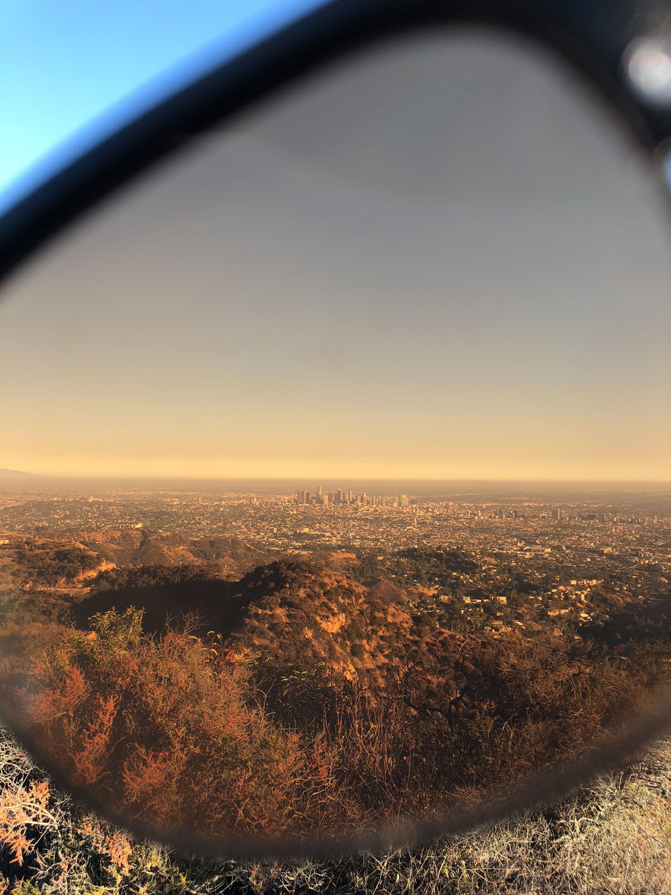 AERIAL VIEW OF CITYSCAPE AGAINST SKY AT SUNSET