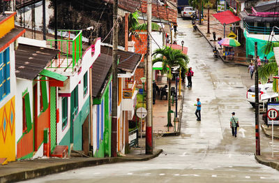 People walking on wet street in city