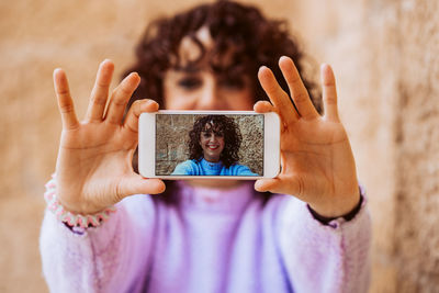 Midsection of woman using mobile phone