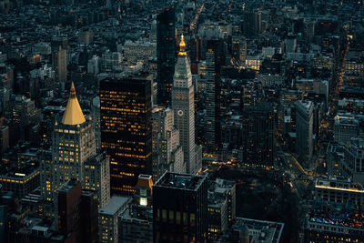 High angle view of city lit up at night