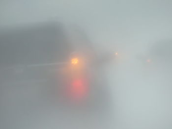 Defocused image of fog against sky during sunset