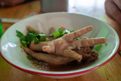 Close-up of hand in plate on table