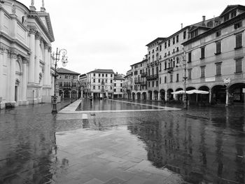 Reflection of buildings on wet street during rainy season