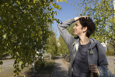 Portrait woman holds trekking sticks, happy caucasian 36 yo hiking female, nordic walking with poles