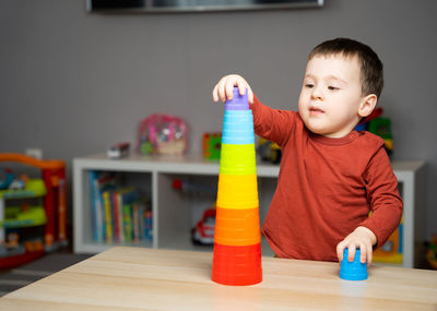 Close-up of cute boy playing with toys at home