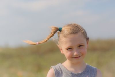 Portrait of smiling girl with braided hair at beach