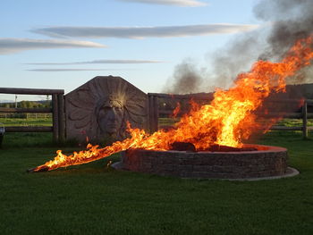 Bonfire on field against sky