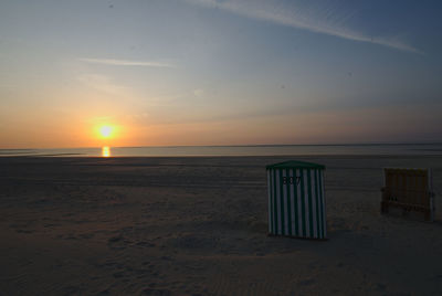 Scenic view of beach against sky during sunset