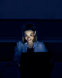 Smiling woman using laptop