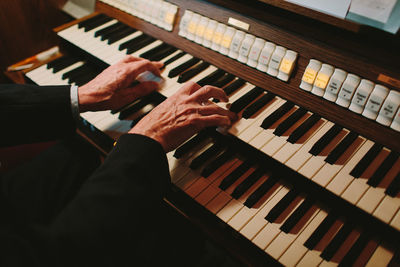 Close-up of man playing piano