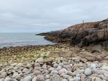 Rocks on beach against sky