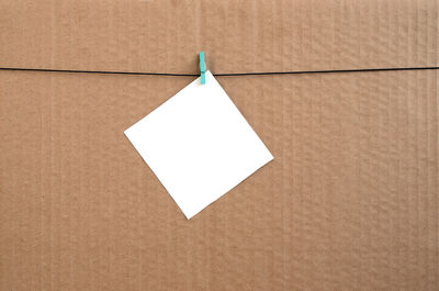 Directly above shot of empty paper attached to clothespins on cardboard paper