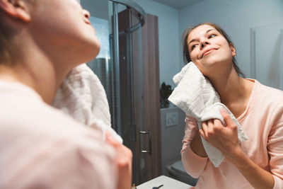 Side view of young woman using mobile phone