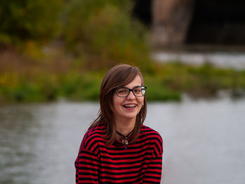 Portrait of smiling young woman in lake