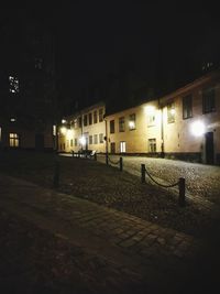 Illuminated city against sky at night