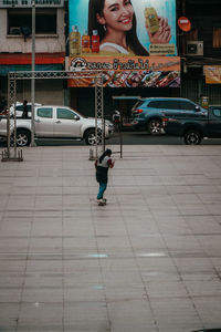 Full length of woman on street in city