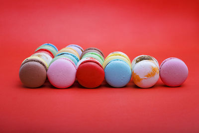 Close-up of multi colored candies against red background