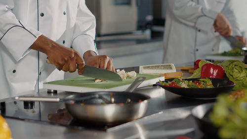 Midsection of chef preparing food in kitchen