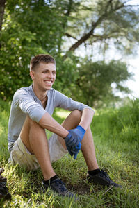 Young man resting after cleaning the park