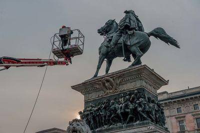 Low angle view of statue against sky