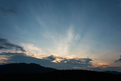 Scenic view of silhouette mountains against sky at sunset