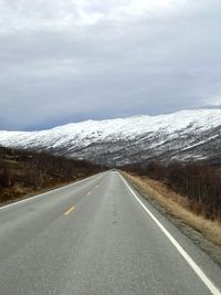 Empty road against sky