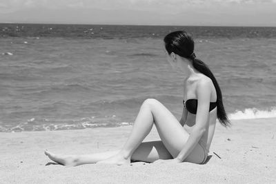 Rear view of people enjoying at beach