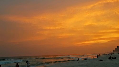 Scenic view of beach against sky during sunset