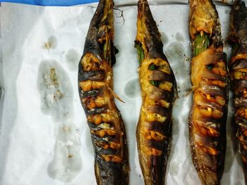 High angle view of fish on barbecue grill