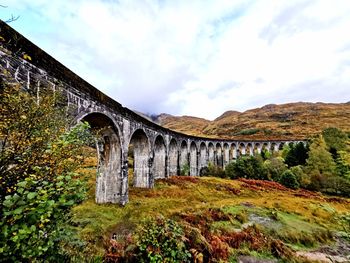 Low angle view of arch bridge against sky