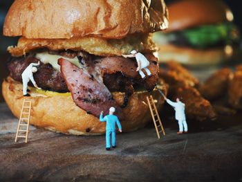 Manual worker figurines on hamburger