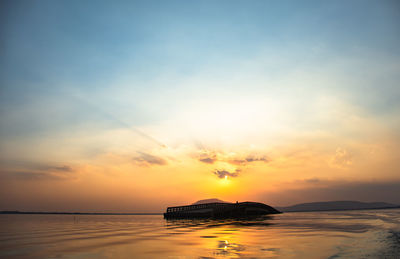 Scenic view of sea against romantic sky at sunset