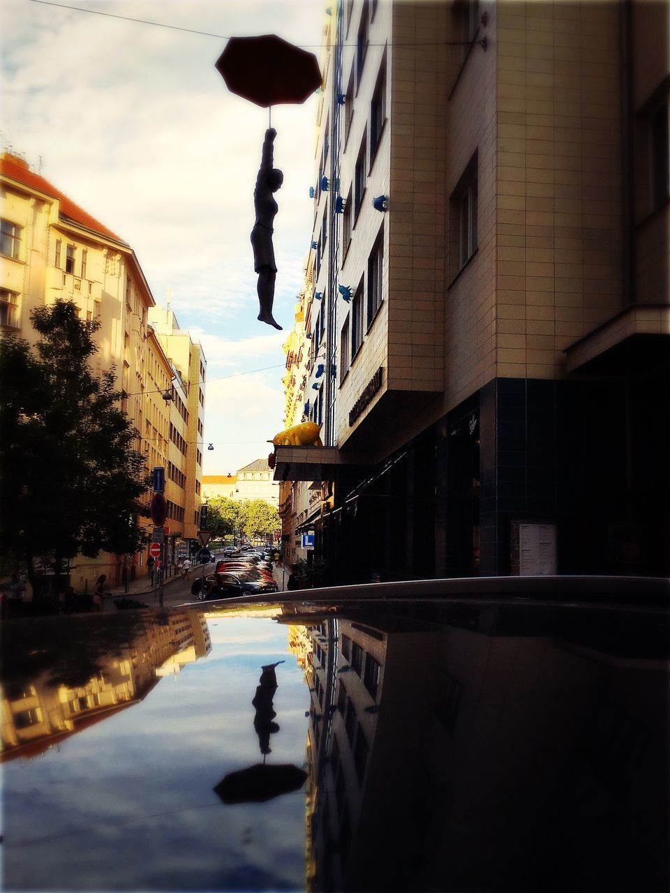 REFLECTION OF BUILDINGS IN PUDDLE