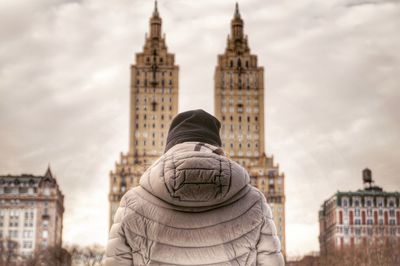 Low angle view of man against buildings