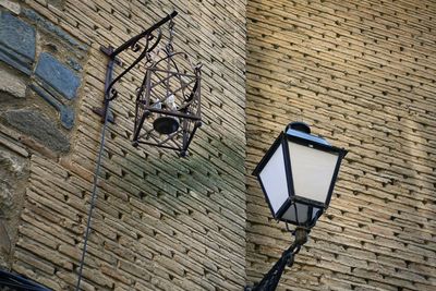 Low angle view of street light against wall