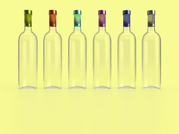 Close-up of glass bottles against white background