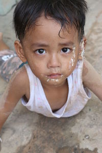 Close-up portrait of cute boy with messy face