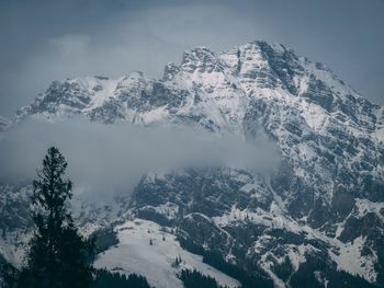 Scenic view of snow covered mountains against sky