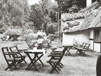 Empty chairs and tables in front of building