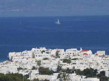 High angle view of buildings by sea against sky