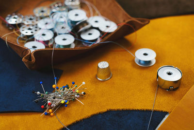 Tailor workplace accessories. close up view of the eco leather and tailoring equipment laying on the