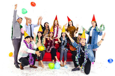 Group of people against multi colored umbrellas