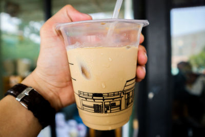 Close-up of hand holding drink