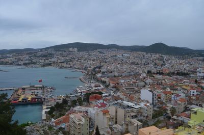 High angle view of townscape by sea against sky