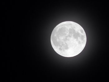 Low angle view of full moon against sky at night