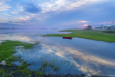 Beautiful sky reflects in coastal maine inlet after sunrise.