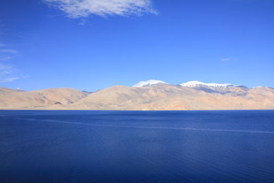 Scenic view of mountains against blue sky