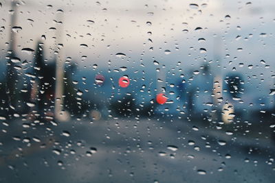 Road seen through wet glass window