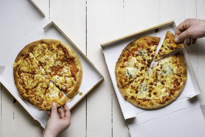 Midsection of person holding pizza