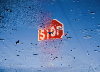 Reflection of road sign on wet floor